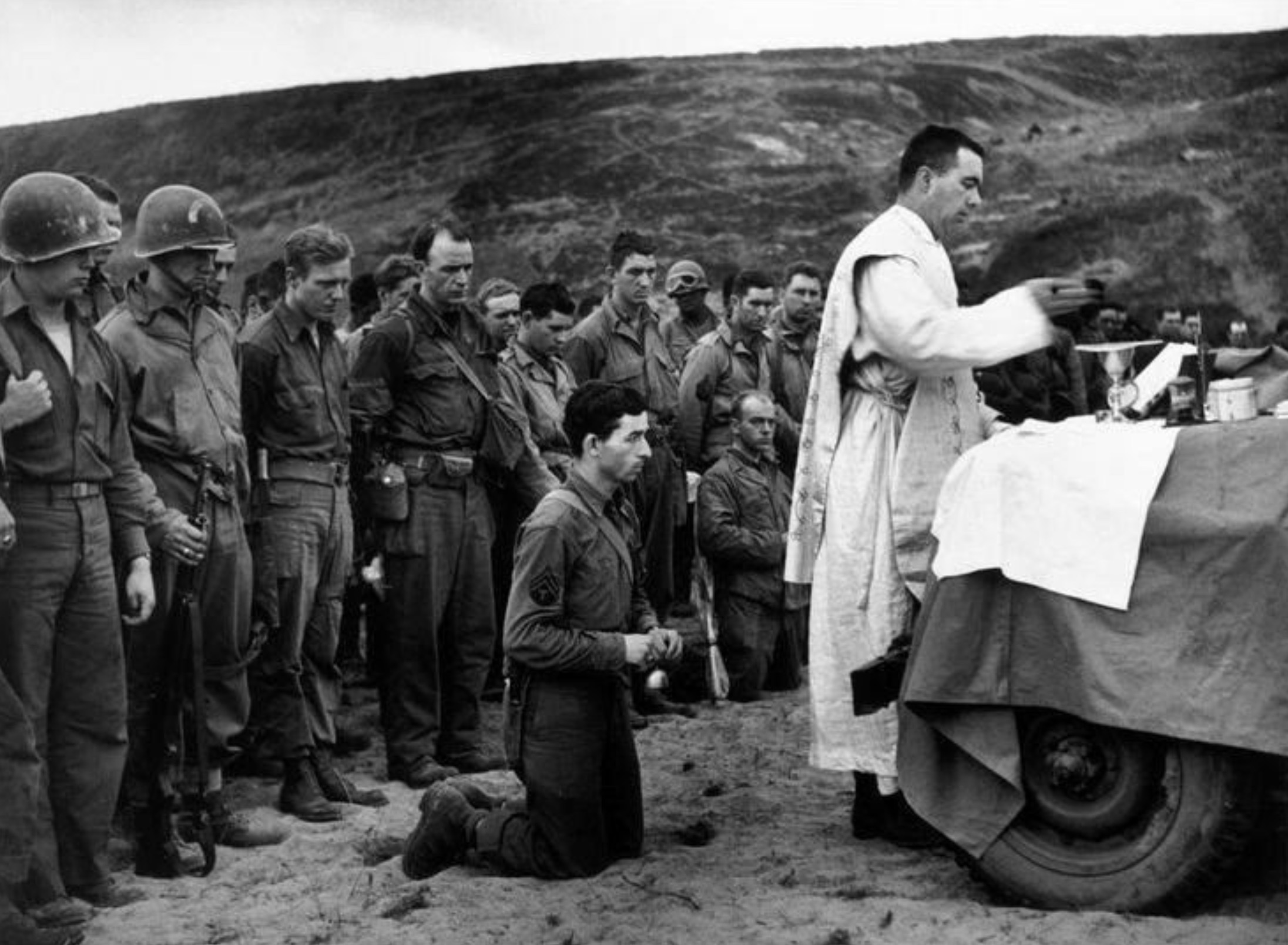 Military chaplain Fr. John McGovern offers the Requiem Mass for the fallen after the D-Day landings 